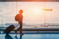 tourist travel to international airport terminal, silhouette of woman passenger with luggage Royalty Free Stock Photo