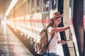 Tourist travel woman looking at the map while walking at train station