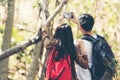 Tourist and traveler asian couple backpack enjoy happy take a photo selfie in the jungle forest nature park . Royalty Free Stock Photo