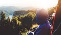 Tourist traveler on background top mountain sits and enjoys the sunset, hiker looking on blue sky clouds, nature panoramic land Royalty Free Stock Photo