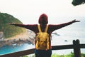 Tourist traveler with backpack standing with raised hands, hiker looking to a valley in trip in spain, hipster young girl enjoying Royalty Free Stock Photo