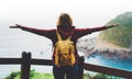 Tourist traveler with backpack standing with raised hands, hiker looking to a valley in trip in spain, hipster young girl enjoying Royalty Free Stock Photo