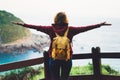 Tourist traveler with backpack standing with raised hands, hiker looking to a valley in trip in spain, hipster young girl enjoying Royalty Free Stock Photo