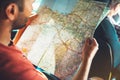 Tourist traveler driving and hold in male hands europe cartography, view and plan tourist way road, trip in transportation auto