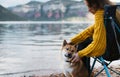 Tourist traveler girl relax tender together friends dog on background mountain landscape, woman hugging pet rest on lake shore