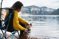 Tourist traveler girl relax tender together friends dog on background mountain scape, woman hugging pet rest on lake shore nature