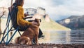 Tourist traveler girl relax together dog on background mountain, fun woman hugging puppy pet on lake shore nature trip, friendship