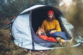 Tourist traveler hugging red shiba inu in camp tent on background froggy rain forest, hiker woman with puppy dog in mist nature Royalty Free Stock Photo