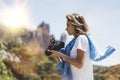 Tourist traveler photographer taking pictures of amazing landscape on vintage photo camera on background valley view mockup sun Royalty Free Stock Photo