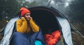 Tourist traveler ralaxing in camp tent in froggy rain forest, closeup happy smile hiker woman enjoy mist nature trip Royalty Free Stock Photo