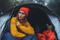 Tourist traveler ralaxing in camp tent in froggy rain forest, hiker woman enjoy mist nature trip, green trekking tourism, rest