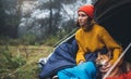 Tourist traveler relax red shiba inu in camp tent on background foggy forest, hiker woman with puppy in mist nature trip, friends Royalty Free Stock Photo