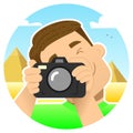 Tourist, traveler; smiling guy with a camera on an excursion in Egypt, against the background of the pyramids; photographs by