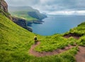 Tourist on trek on Mykines island. Gloomy morning view of Mykines village, Faroe Islands, Denmark, Europe. Fantastic seascape of A