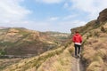 Tourist trekking on marked trail in the Golden Gate Highlands National Park, South Africa. Scenic table mountains, canyons and cli Royalty Free Stock Photo
