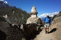 tourist trekking next to old buddhist stupa on the Everest trek in Himalayas mountains, Nepal