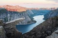 Tourist on Trolltunga rock in Norway mountains Royalty Free Stock Photo