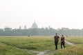 Tourist vacations couple walking in Maidan play garden area of Brigade Parade ground in Summer sunset time. Famous Victoria