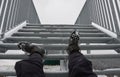 The tourist view from with metal stairs glides dangerously in the winter. hiker in hiking boots fell from the skin and lying injur