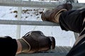 The tourist view from with metal stairs glides dangerously in the winter. hiker in hiking boots fell from the skin and lying injur