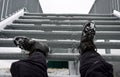 The tourist view from with metal stairs glides dangerously in the winter. hiker in hiking boots fell from the skin and lying injur