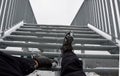 The tourist view from with metal stairs glides dangerously in the winter. hiker in hiking boots fell from the skin and lying injur