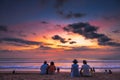 Tourist viewing sunset at Kuta Beach, Bali.