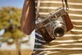 Tourist with vintage camera in the countryside. Travel background.