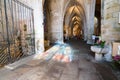 Tourist visit the Basilica de Saint-Saveur in Dinan with reflections of stained glass windows on the stone floor Royalty Free Stock Photo