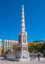 Tourist visiting the memorial obelisk dedicated to General Torrijos in Plaza de la Merced