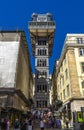 Tourist visiting the Santa Justa Elevator or Elevador do Carmo. Modernist style metal structure elevator.