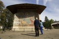 Tourist at Voronet monastery, Romania Royalty Free Stock Photo