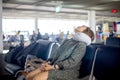 Tourist wait for flight and feel tired sleep on the chair