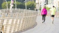 people run in city pedestrian bridge with exterior modern building