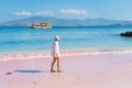 Tourist walk on pink beach in Komodo national park, Flores island in Indonesia