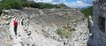 Tourist walking in ancient theatre in Termessos