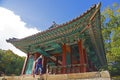 A tourist walking into a building in Changdeokgung secret garden, Seoul