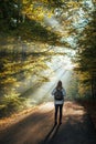 Tourist walking on country road in woodland Royalty Free Stock Photo