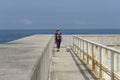 Tourist walking with a dog on a port structure Royalty Free Stock Photo