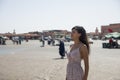 Tourist walking and enjoying the Jmaa El Fna square, which is the main square in Marrakech