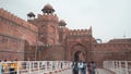 Tourist walking in from the main entrance to ancient old historial Red Fort Delhi India asia front view