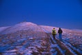 Tourist walking on the mountains ridge in winter late morning landscape Royalty Free Stock Photo