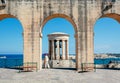 Tourist walking under arches of historical city with view on War siege Memorial Royalty Free Stock Photo