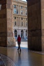 Tourist walking under the arches of Via XX Setembre, the main boulevard in Genoa