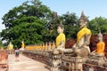 Tourist walking watching ancient Buddha statues at Wat Yai Chaimongkol temple in Ayutthaya, Thailand. Royalty Free Stock Photo
