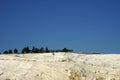 Tourist walking on white travertines terrace of Pamukkale landscape Royalty Free Stock Photo