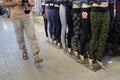 Tourist walks next to line of dummies in tights, Shiraz, Iran.