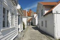 Tourist walks by the street of the old town in Stavanger, Norway.
