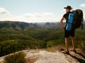 Tourist watch land from mountain top. Man wear backpack Royalty Free Stock Photo