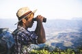 Tourists are viewing binoculars in a cloudy sky from the top of the mountain. Royalty Free Stock Photo